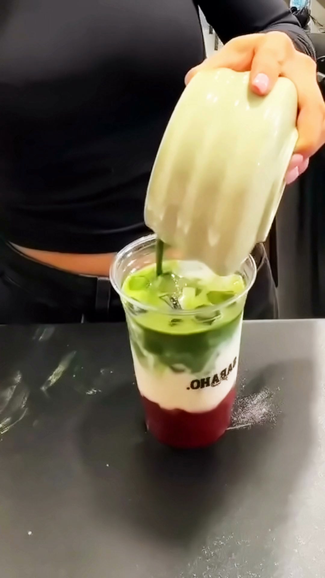 A Sabaho strawberry cold foam matcha being built: matcha, then cold foam, then the finished drink